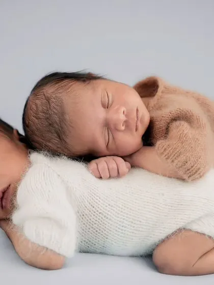 A precious and serene portrait of newborn twins sleeping soundly together, showcasing my experience in safely and beautifully posing multiple babies.