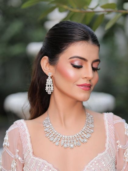 Eyes closed, the beauty speaks for itself. The soft pink shimmer on the lids and the perfectly highlighted cheekbones create a look of pure elegance.