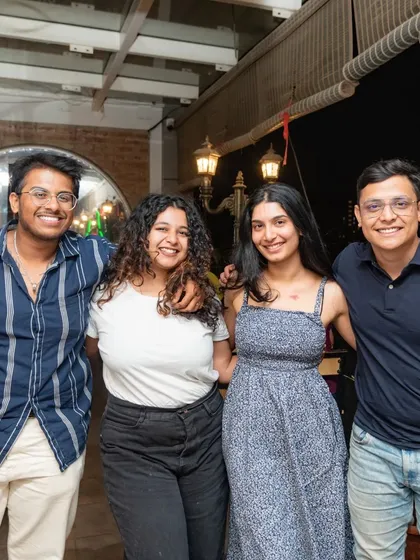 This group of friends is enjoying the rooftop ambiance.