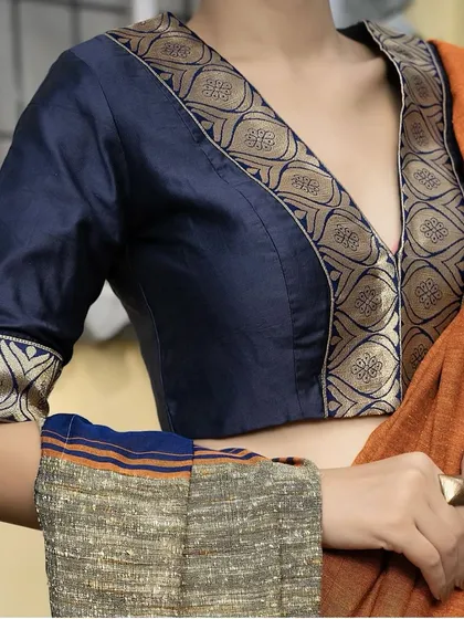 Elegance redefined in rich navy blue. I designed this blouse with a deep V-neck and a stunning brocade border on premium silk fabric, creating a perfect blend of grace and style for your special events.