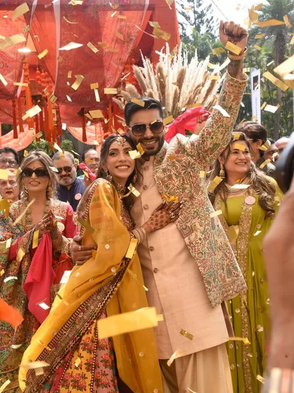 It's the moments in between that matter most. The pure, uninhibited joy of the couple amidst a shower of gold confetti captures the vibrant energy we strive to create at every celebration. This is what a festival of love looks like.
