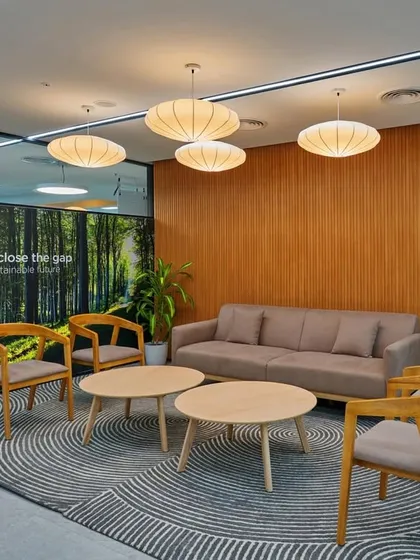 First impressions matter. We designed this corporate reception area with natural wood furniture, contemporary pendant lighting, and a soothing color palette to create a calm and professional atmosphere for visitors and employees.
