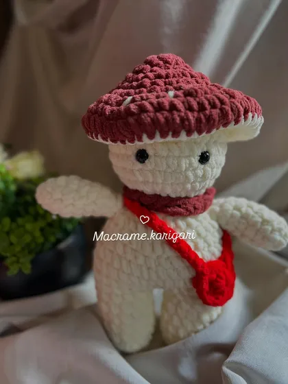 A front view of our handmade mushroom toy. The combination of the textured yarn and cute design makes it a standout piece in our collection.
