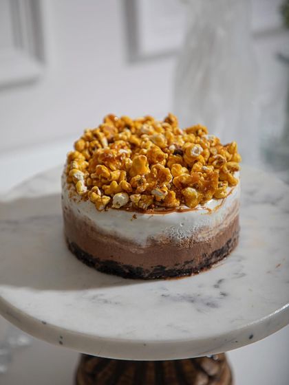 Our Caramelised Popcorn and Milk Chocolate ice cream cake, where sweet and salty flavours meet. The crunchy popcorn topping adds a playful texture to this decadent treat.