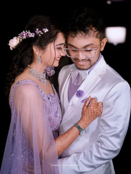 An intimate moment between the couple, their matching lavender outfits perfectly complementing the reception's romantic theme.