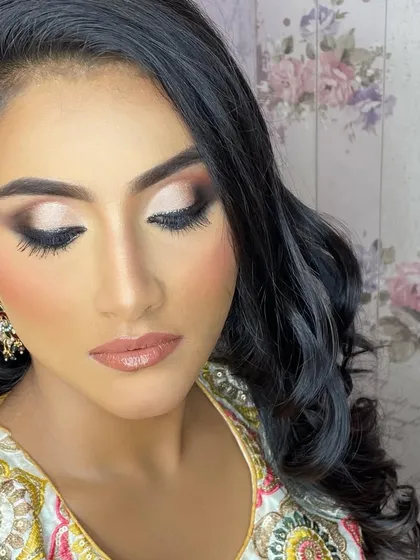 A close-up of the soft, smokey eye and glossy nude lip that complements the dewy skin, creating a modern and sophisticated party look.
