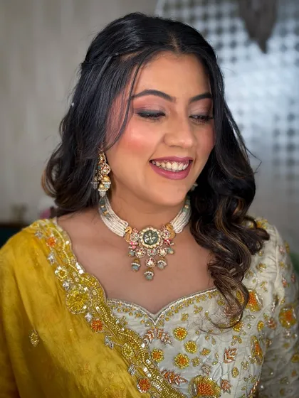 A happy, smiling bride. The makeup is light and enhances her natural glow.
