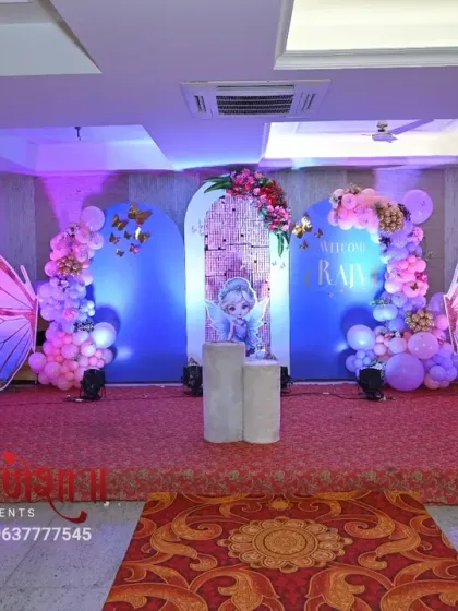 A straight-on view of the butterfly birthday stage, showcasing the symmetry of the design. The two large wings flank the central arch, creating a balanced and photogenic backdrop for the cake-cutting ceremony.