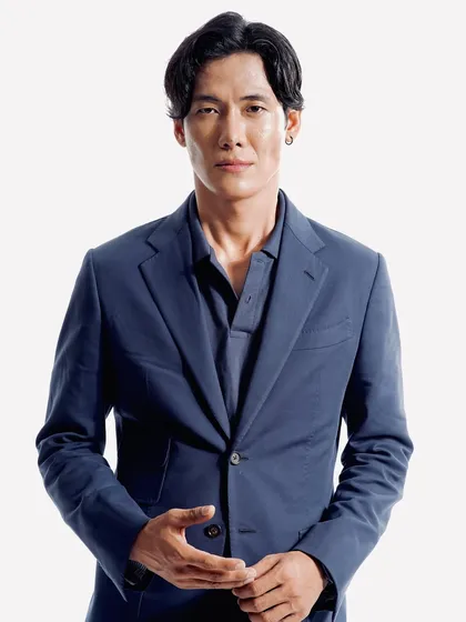 A full-length shot of the same professional look. The grooming is subtle, ensuring the focus is on the model's expression and the sharp tailoring of his suit.