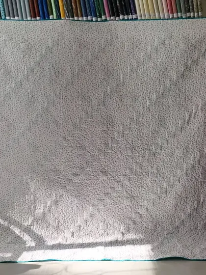 The simple dotted backing fabric for the diagonal star quilt.