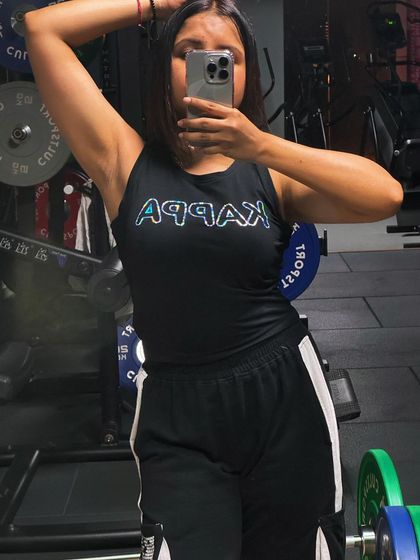 A confident pose showing off the results of consistent upper body training. Strength training helps build toned and defined muscles.