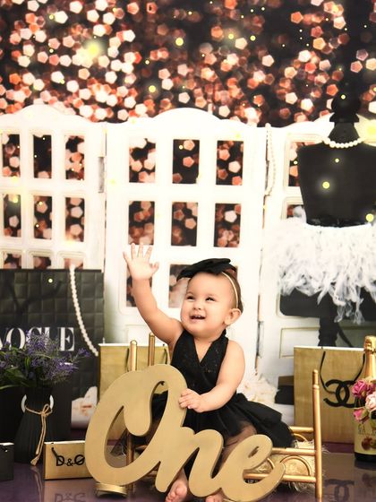 For the little diva turning one, a fashion-themed shoot is a must. Surrounded by iconic brands and sparkly lights, she is the star of her own glamorous show.