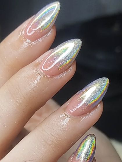 A close-up of a stunning holographic chrome finish on almond-shaped nails. The way the light reflects a rainbow of colors is absolutely mesmerizing.