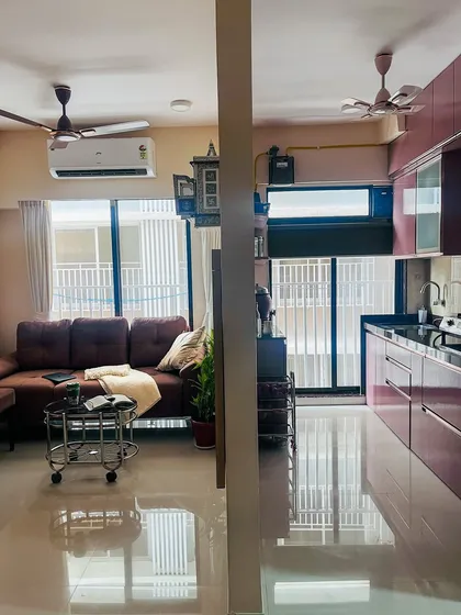 A split view showing the living room and kitchen in one of our projects. This demonstrates how we create a visual connection between spaces while still giving each area its own distinct character.