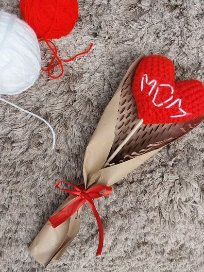 A special bouquet for Mother's Day, featuring a single red heart with "MOM" embroidered on it. It's a simple, heartfelt way to show your love.