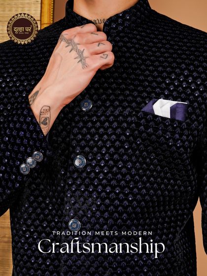 Where tradition meets modern craftsmanship. A close-up of a black velvet jacket with intricate texture and a modern pocket square.