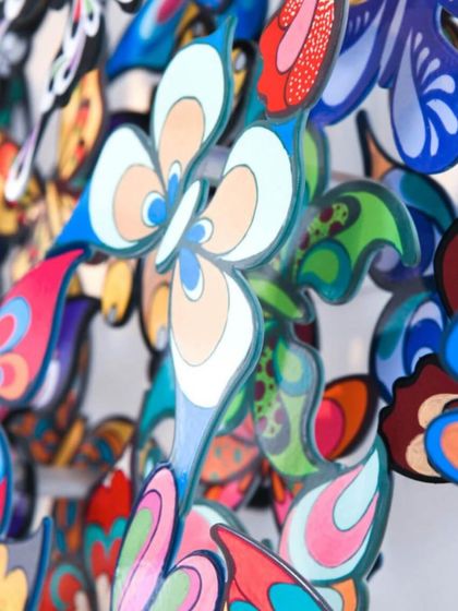 A close-up detail of the intricate patterns on David Kracov's metal butterflies. Each element is a miniature work of art, contributing to a larger narrative of color, wit, and pop culture.