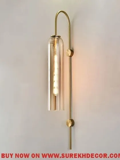 A variation with a golden glass shade, this elegant columnar wall lamp offers a warmer, more classic look. The imported antique brass finish and 780mm height make it a dramatic and sophisticated lighting choice.