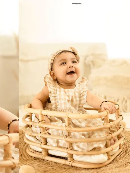 A bright and cheerful portrait of a baby girl enjoying her milestone photoshoot.