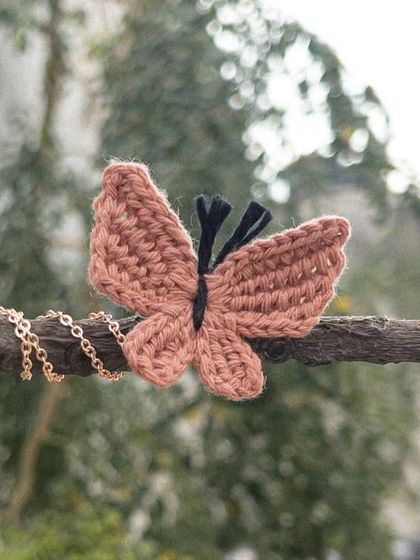 The 'Titli' necklace in a lovely dusty rose color. It comes with the crocheted butterfly and a chain, which can be customized.