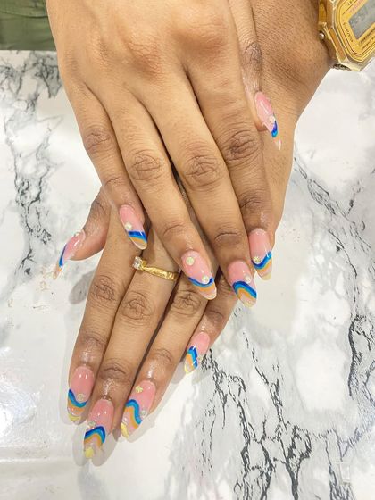 A side view of the abstract wavy nail art design. This angle shows the smooth application and shape of the almond nail extensions created by the student.