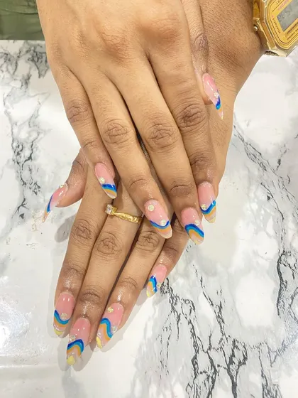 A playful and colorful abstract wave design on long almond-shaped nails.