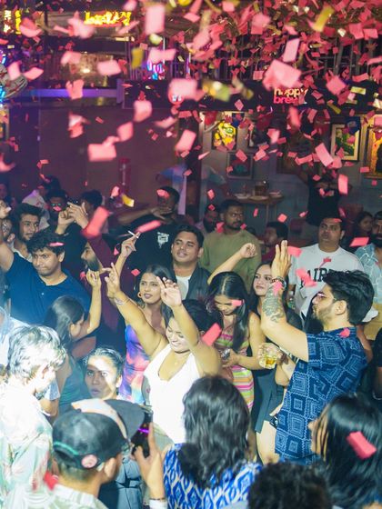 A confetti shower over a packed dance floor creates a moment of pure euphoria.