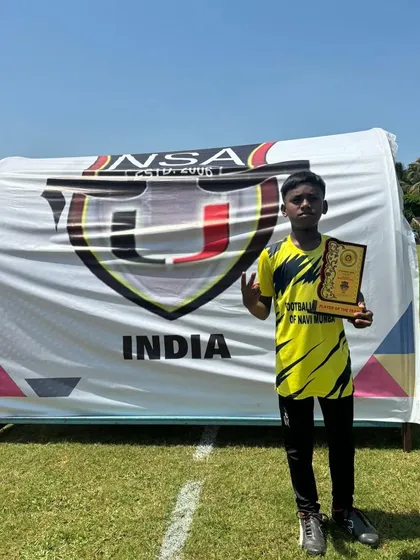 Kanak proudly shows off his award at the Goa Football Festival.