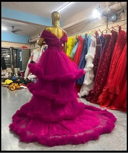 A view of the back of our magenta pink ruffled gown. The corset-style back ensures a perfect fit, while the tiered ruffles create a dramatic and beautiful train.