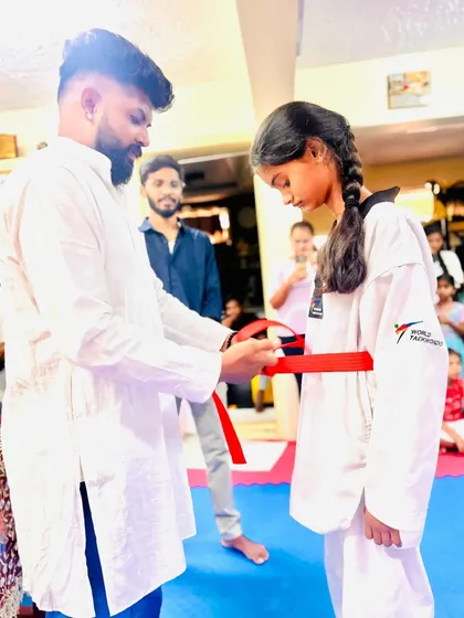 This young lady has earned her red belt through consistent effort.