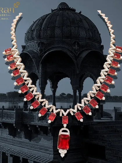A modern and fiery necklace crafted with red stones and sparkling zircons. This piece is perfect for a cocktail party or a contemporary reception look.