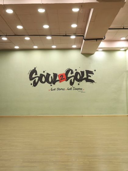 The main wall of our studio, featuring our motto: "We Dance. We Inspire." This space is ready for your next dance practice or video shoot.