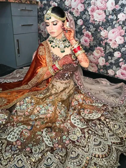 Another angle of the bride in the peacock lehenga, highlighting the rich colors and textures.