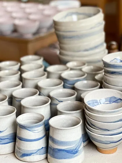 My studio often fills with pieces for custom commissions. This batch of tumblers and bowls, with their soft blue strokes, was created for a client, showing how I can bring a specific vision to life in quantity.