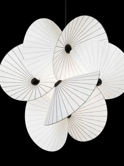 A studio shot of the Serpentine Light against a black background, allowing its complex, spiraling form to be fully appreciated as a piece of sculpture.