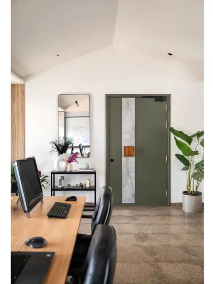 The entrance to the Project Rooftop office, seen from a workstation. The gabled ceiling and custom green door create a unique and inspiring view. I believe your workspace should be filled with details that you love to look at every day.
