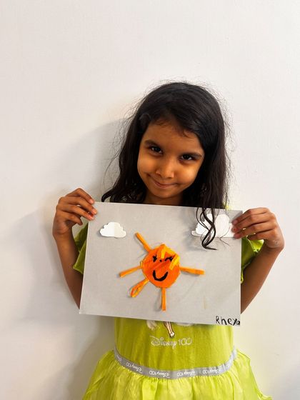 This young artist's sun craft is shining bright, a wonderful result from our paper crafting session.