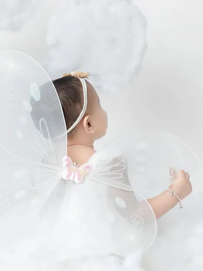 A glimpse of her delicate fairy wings. This shot from the back is so artistic and sweet, showing a different perspective.