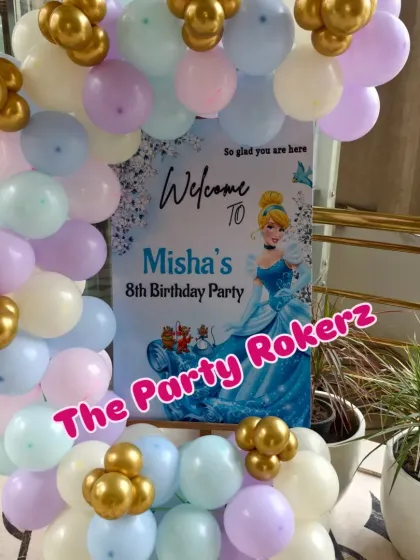 A close-up of the Cinderella-themed welcome sign, surrounded by a pastel balloon garland.