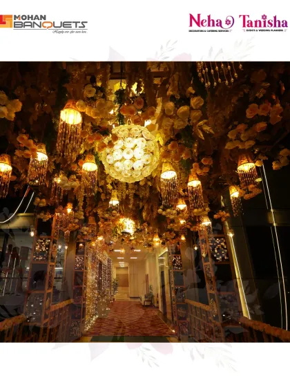 We create enchanting pathways for your guests. This stunning entrance at Mohan Banquets features a ceiling covered in flowers and hanging crystal chandeliers, lighting the way to the celebration.