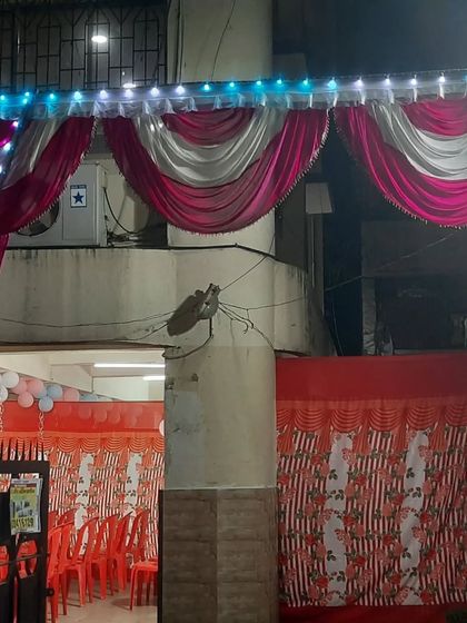 A view of the pandal and seating from the outside, showing how it is integrated with the building structure.