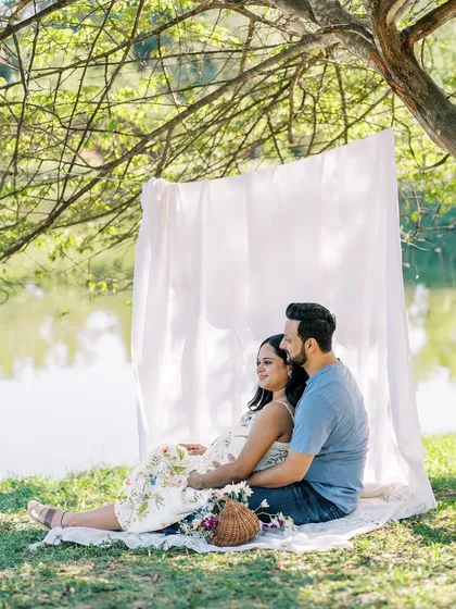 We created a simple, elegant backdrop for this outdoor picnic-style shot by the lake. It provides a clean setting that keeps the focus on the couple's relaxed and happy interaction.