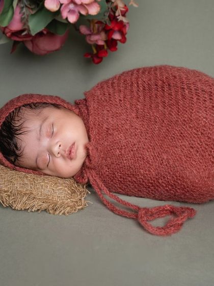 A side profile captures the delicate curve of their nose and lips. I use soft, natural posing to keep the baby comfortable while highlighting their newborn features.