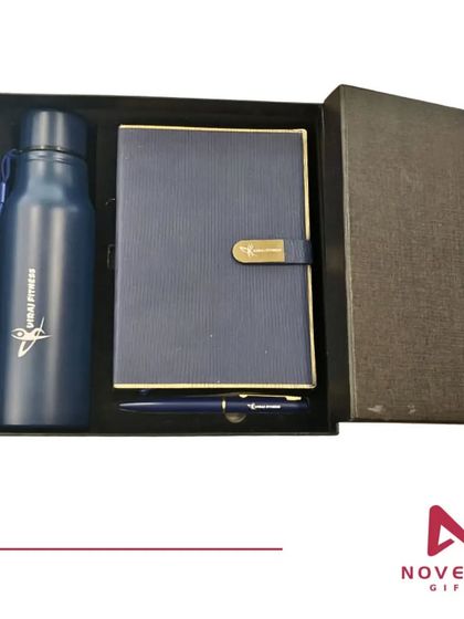 A customized 3-in-1 gift set for a fitness brand's new joiners. It includes a branded water bottle, a diary with a custom metal clasp, and a matching pen.