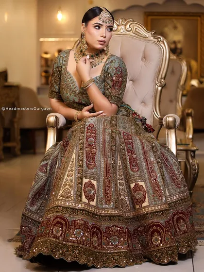 A full-length shot of our model in a magnificent bridal lehenga. The makeup is designed to be flawless from every distance, ensuring a regal and commanding presence.