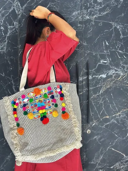 This shot captures the playful movement of the pom-pom tassels, adding a dynamic and fun element to your look.