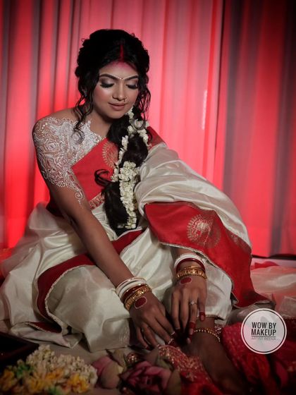 The final touches of alta on the feet, a beautiful and significant part of the traditional Bengali attire.