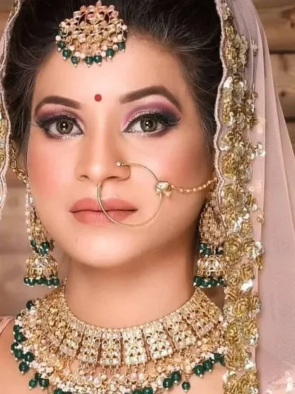 A bride wearing a classic Kundan choker with green beads and a matching nath. This is one of my most popular and versatile bridal sets.
