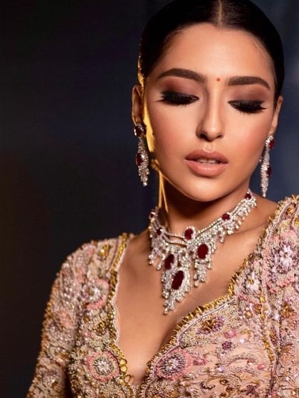 The same reception look with eyes closed, showcasing the soft, shimmery eyeshadow.