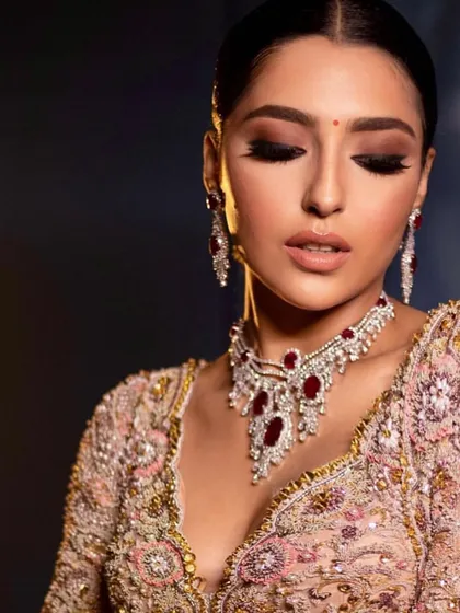 The same reception look with eyes closed, showcasing the soft, shimmery eyeshadow.